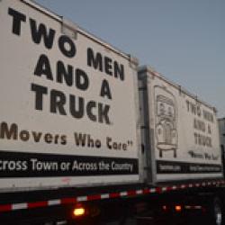 a truck with value flex moving containers on it